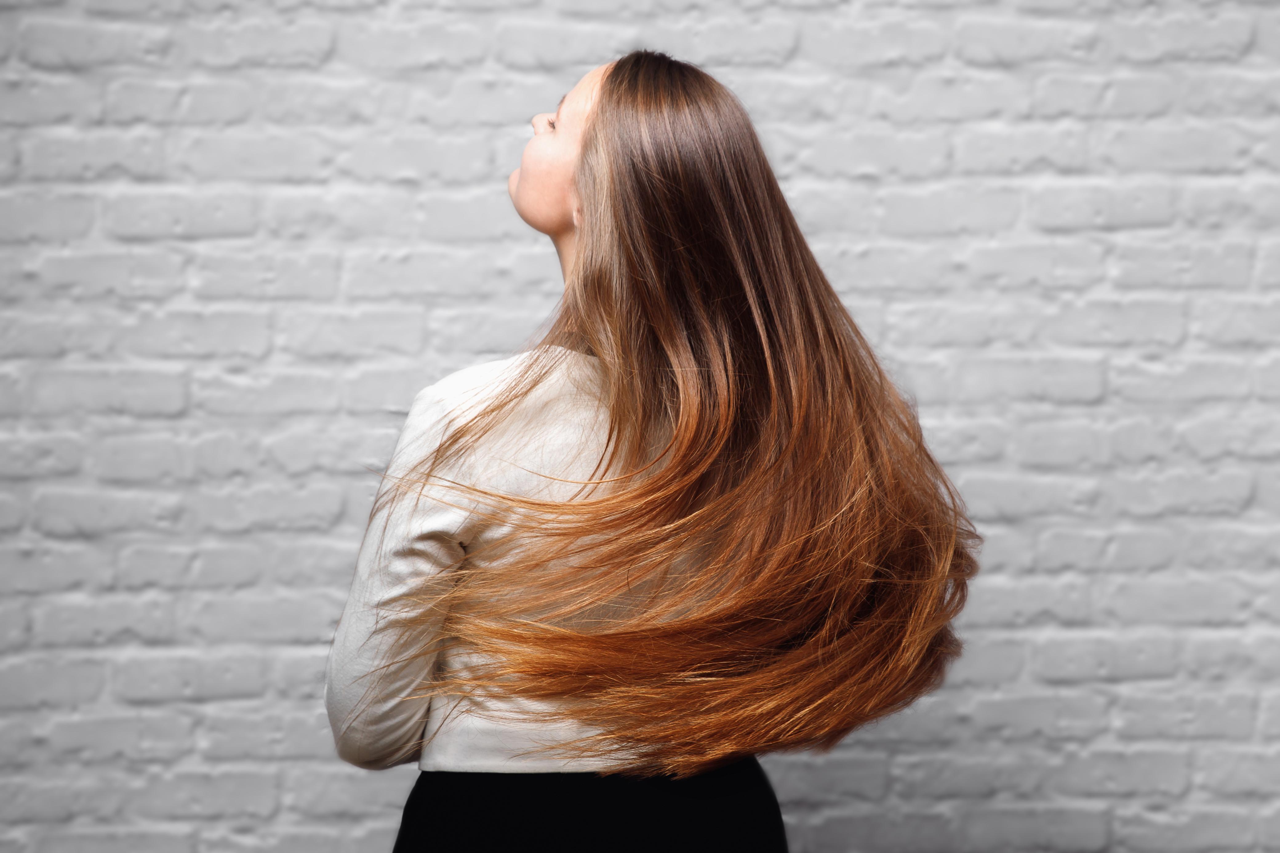 Healthy long shiny hair after restorative treatment